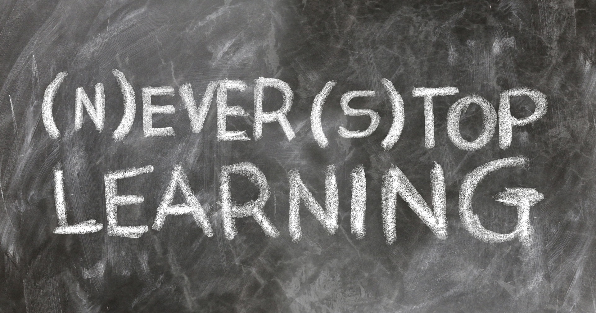 a blackboard showing the text - "never stop learning"